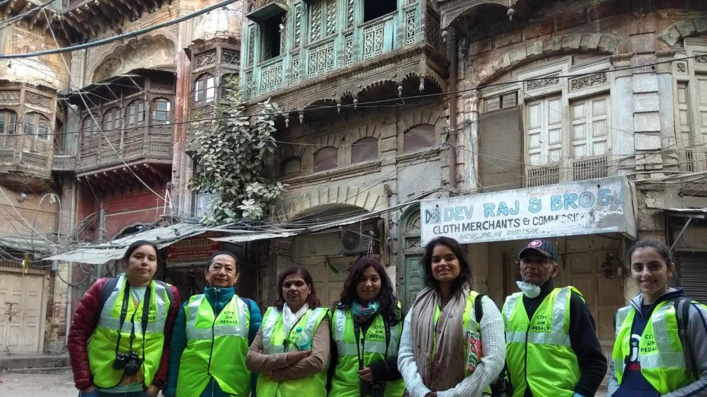 Mixed group of travelers in the narrow lanes of the walled city of Amritsar during the Amritsar Heritage Walking Tour