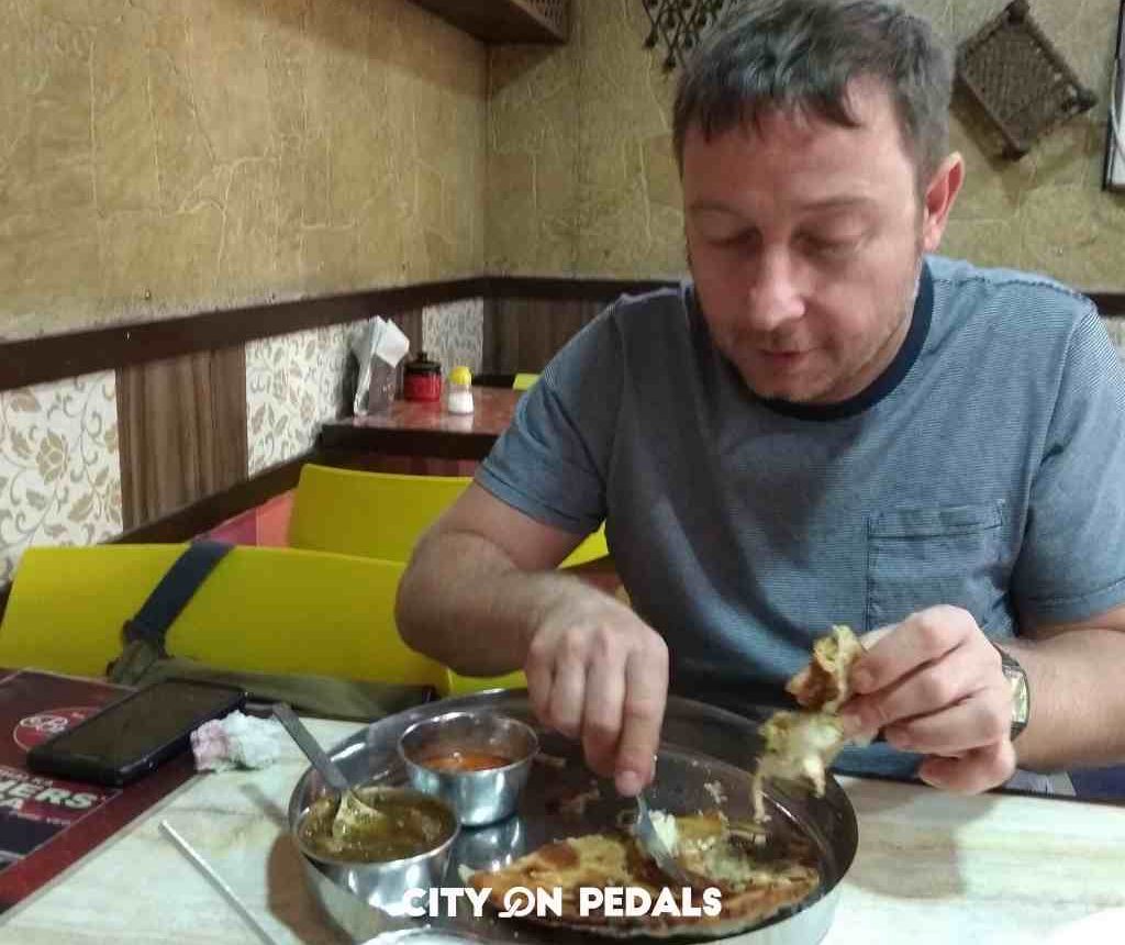 Traveler enjoying a traditional breakfast during the Amritsar Heritage Walking Tour