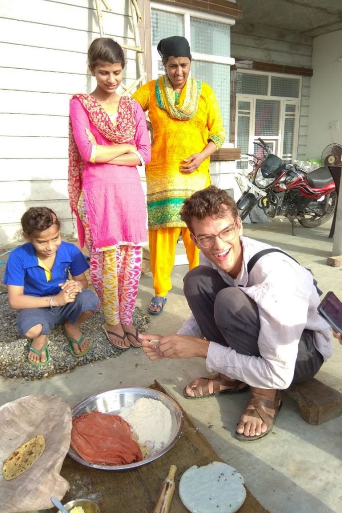 German traveler making rotis on Amritsar Village Tour